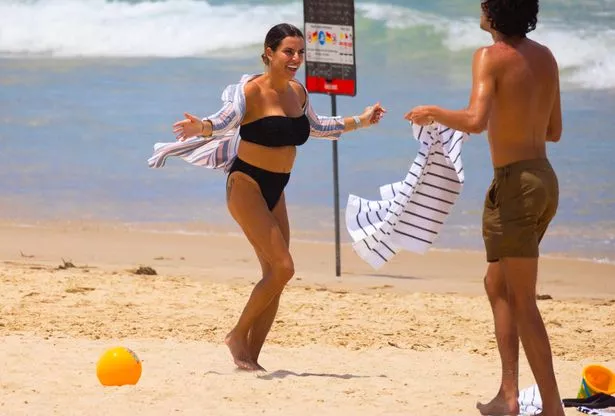 Rachael Bellew enjoys a windy day on the beach with her family in Surfers Paradise. No Credit