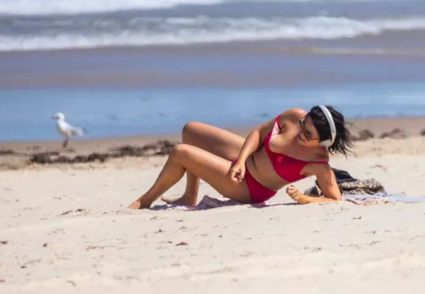 Farage's girlfriend lounged on the golden sands of the Aussie beach