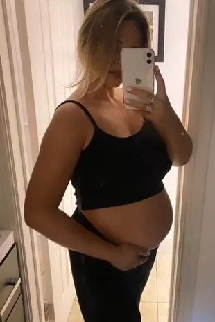 emily posing with her bump on show