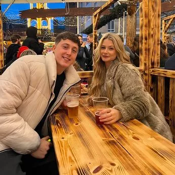 young man and woman sitting at table with drinks