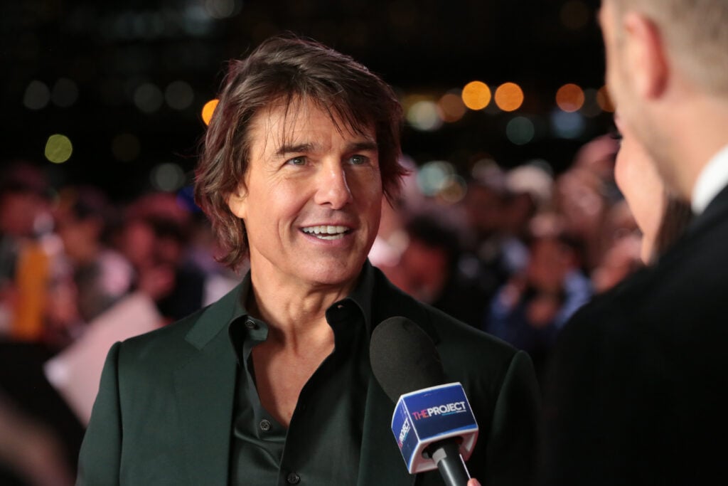 Tom Cruise offers a creepy smile during an interview in 2023.