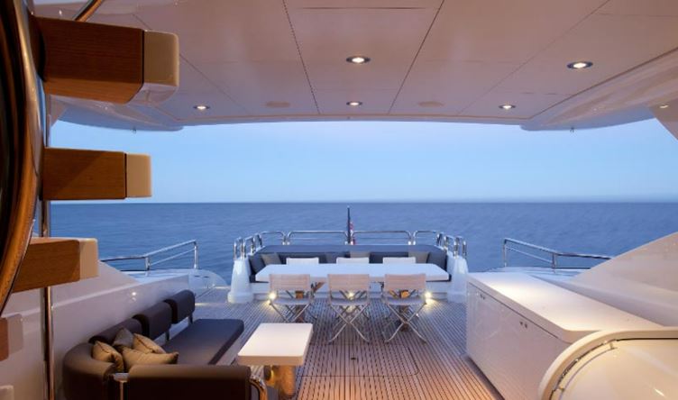 A glam outside seating area is located at the rear of the luxury vessel