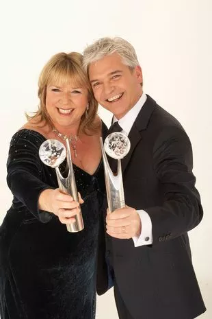 Fern Britton and Phillip Schofield holding awards