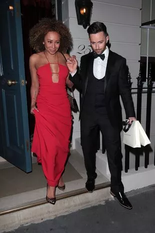 Mel B turned heads in a red maxi dress as her fiancé Rory McPhee lent her an arm