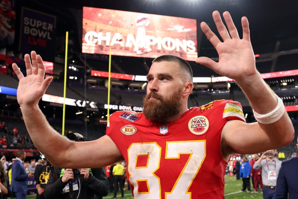 Travis Kelce showing off his 87 jersey in February of 2024.