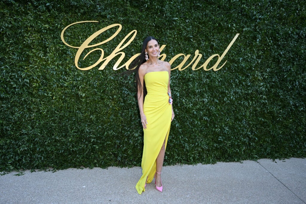 Demi Moore in May of 2024, posing in a bright dress.