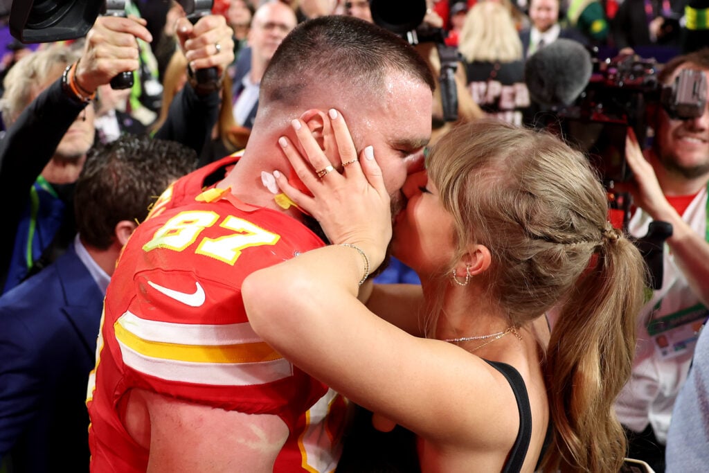 Taylor Swift and Travis Kelce kiss at the 2024 Super Bowl in February.