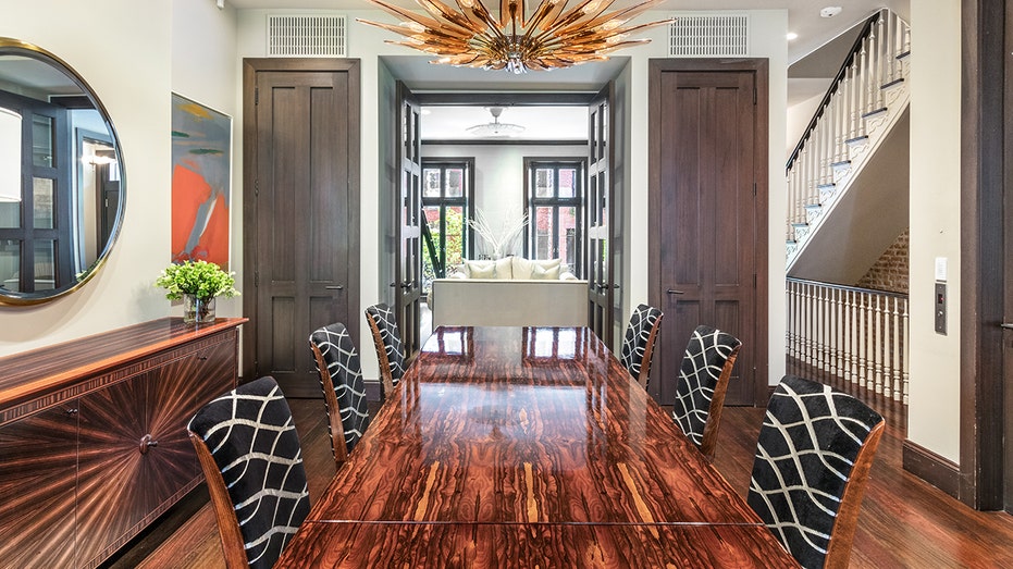 A dining room with shelving and a mirror