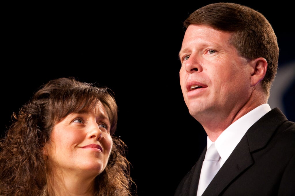 Jim Bob and Michelle Duggar speak on stage at a political rally.