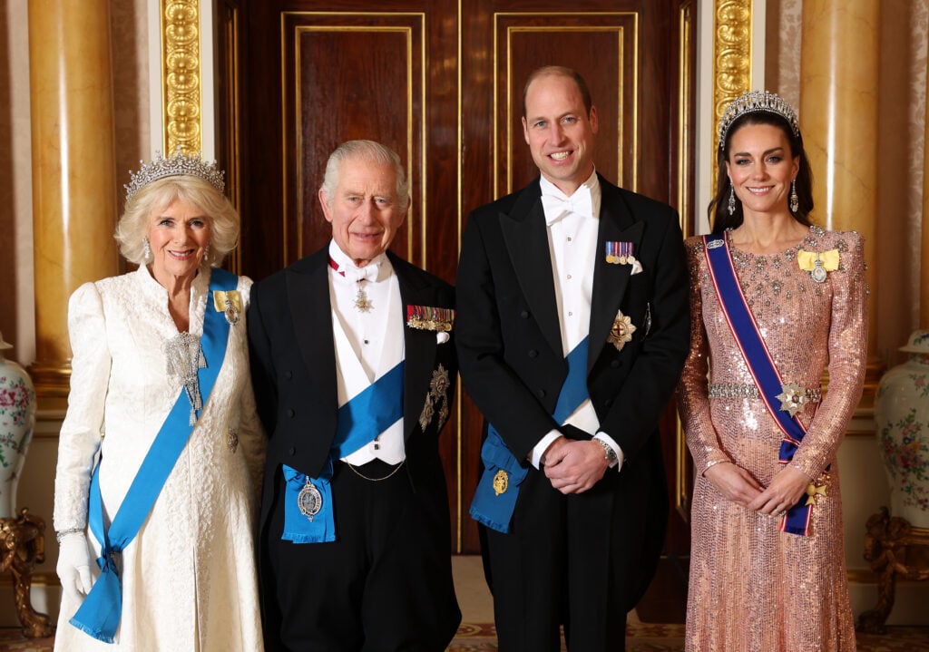 LONDON, ENGLAND - Queen Camilla, King Charles III, Prince William, Prince of Wales and Catherine, Princess of Wales pose for a photograph ahead of The Diplomatic Reception in the 1844 Room at Buckingham Palace on December 05, 2023 in London, England.