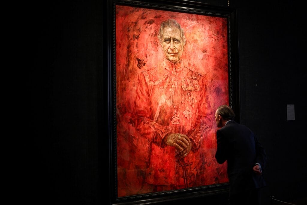 A visitor looks at the new official portrait of King Charles III, painted by British artist Jonathan Yeo, displayed at the Philip Mould gallery, on Pall Mall, central London, on May 16, 2024 following its official unveiling two days ago at Buckingham Palace. 