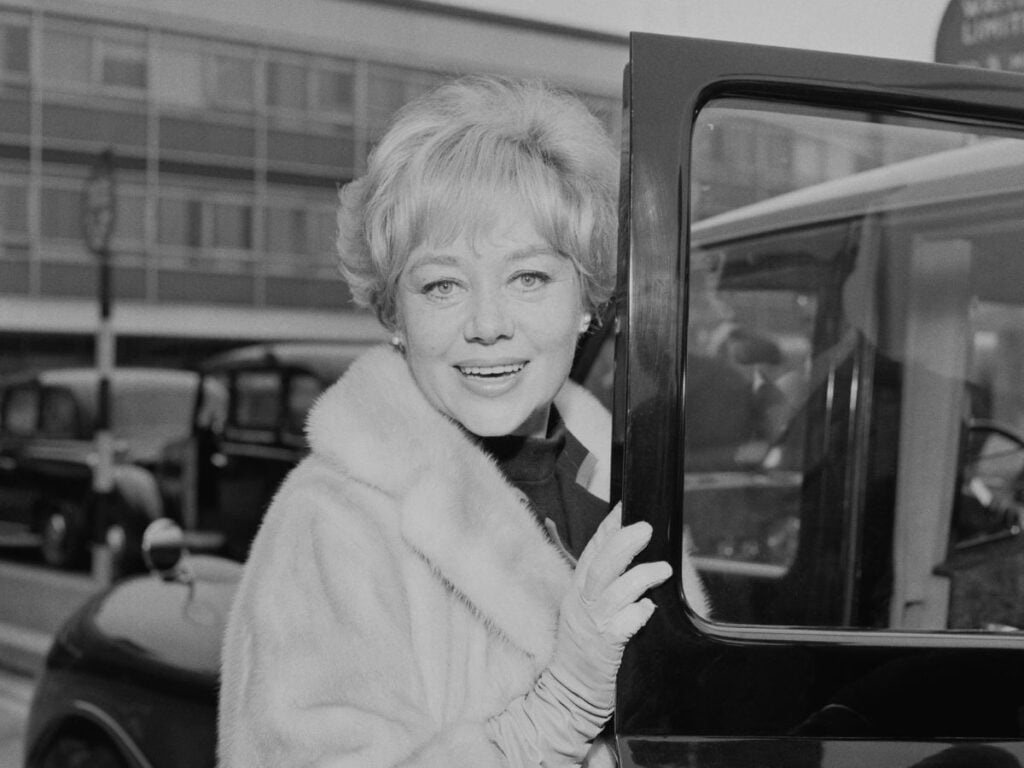 Welsh actress Glynis Johns enters a taxi at London Airport, UK, 15th May 1966