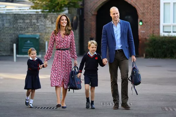 Kate Middleton and Prince William walking with George and Charlotte, the kids are dressed in school informs