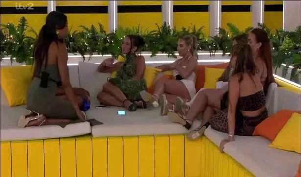 The girls together on some kind of sofa