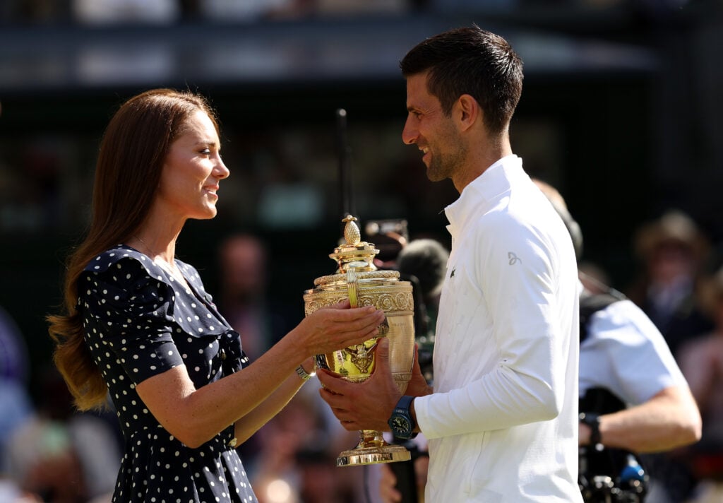 Catherine, Duchess of Cambridge hands over the trophy to winner Novak Djokovic of Serbia following his victory against Nick Kyrgios of Australia during their Men's Singles Final match on day fourteen of The Championships Wimbledon 2022. 