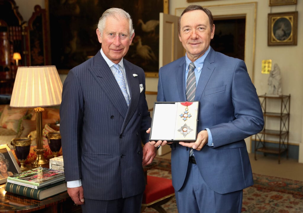 Prince Charles, Prince of Wales presents actor Kevin Spacey with his honorary KBE for services to the theatre, arts education and international culture at Clarence House on June 16, 2016 in London, England.  