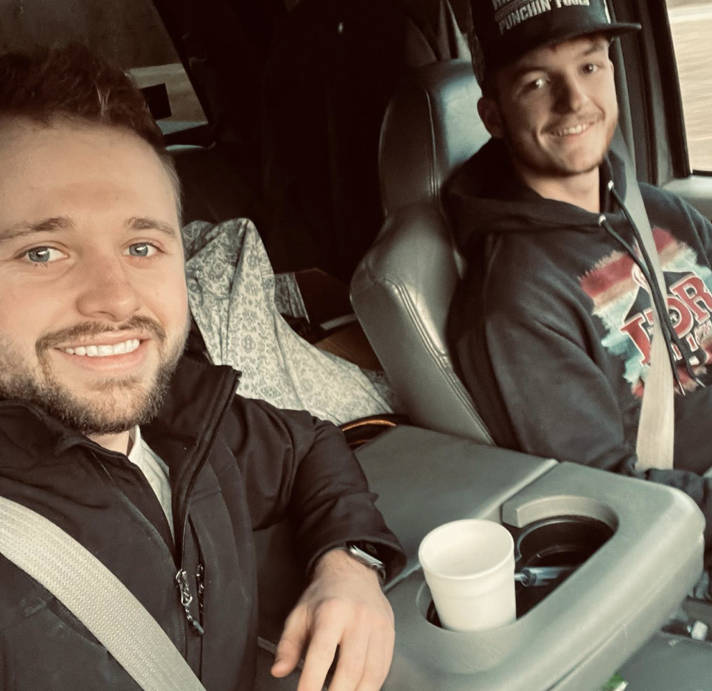 Jason Duggar sits shotgun in a pickup truck driven by a friend of his.