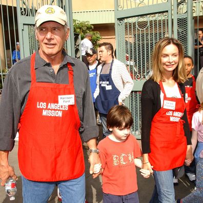 Actor Harrison Ford and actress Calista Flockhart with son Liam participate in serving Thanksgiving dinner to the Skid Row homeless at the Los Angeles Mission hosted by Kirk Douglas and Anne Douglas on November 21, 2007 in Downtown Los Angeles, California. 