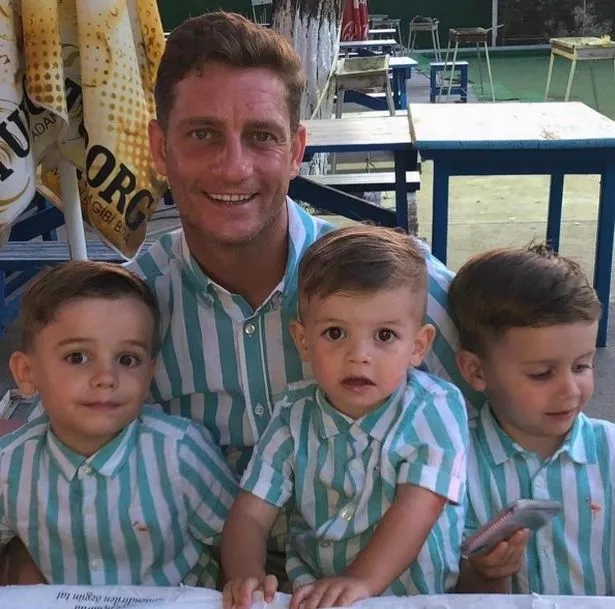 Philip Olivier poses proudly with his three sons