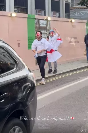 Mark Wright and Olly Murs on the street with their faces painted with the England flag