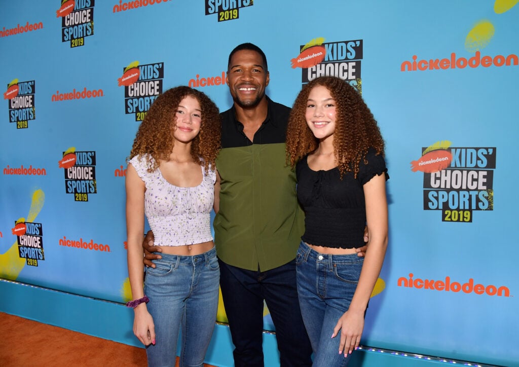 Michael Strahan poses with his daughters on the red carpet of the Kids' Choice Awards.