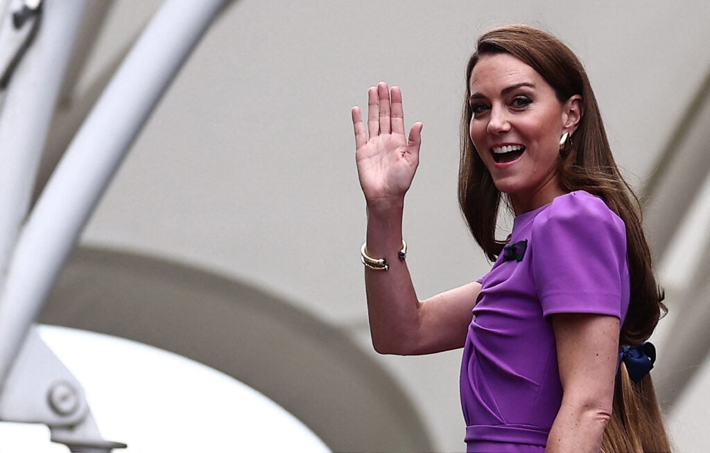 Catherine, Princess of Wales waves as she arrives to attend the men's singles final tennis match on the fourteenth day of the 2024 Wimbledon Championships.