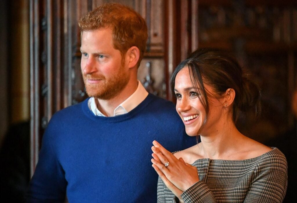 Prince Harry and Meghan Markle smiling together, looking so in love. 