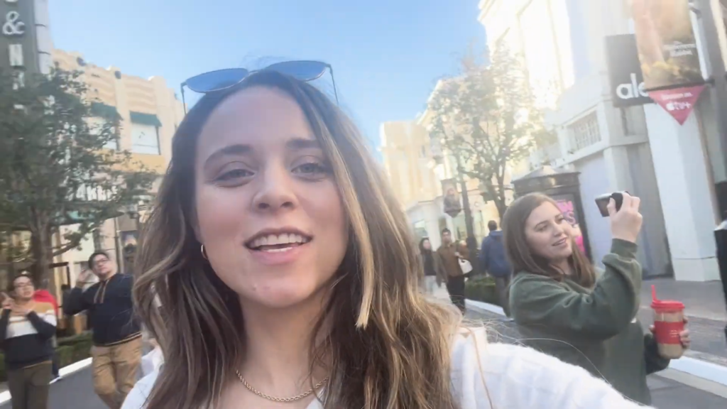 Jinger Duggar holds the camera and vlogs, showing sister Joy-Anna Duggar in the background.