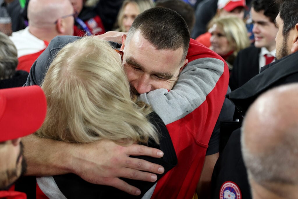 Donna Kelce embraces her son, Travis Kelce. She is one of his two parents.