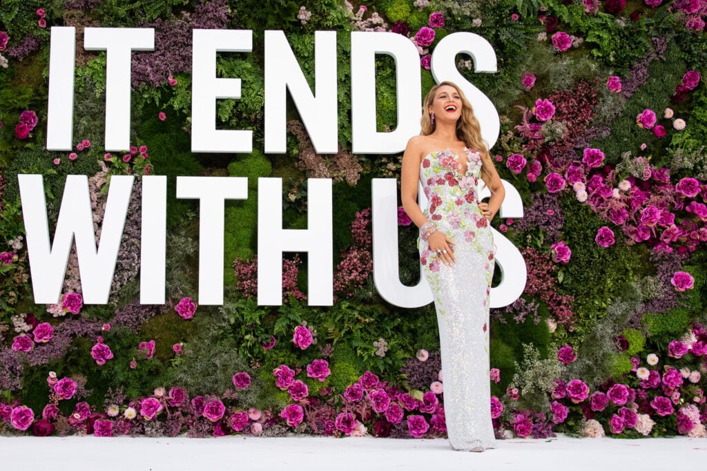 Blake Lively in front of a giant It Ends With Us sign on August 8, 2024.