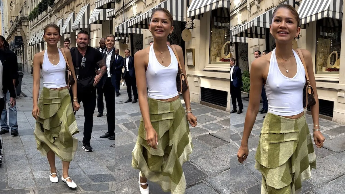 Wearing a white top and green skirt, Zendaya greets paparazzi outside of her Paris hotel