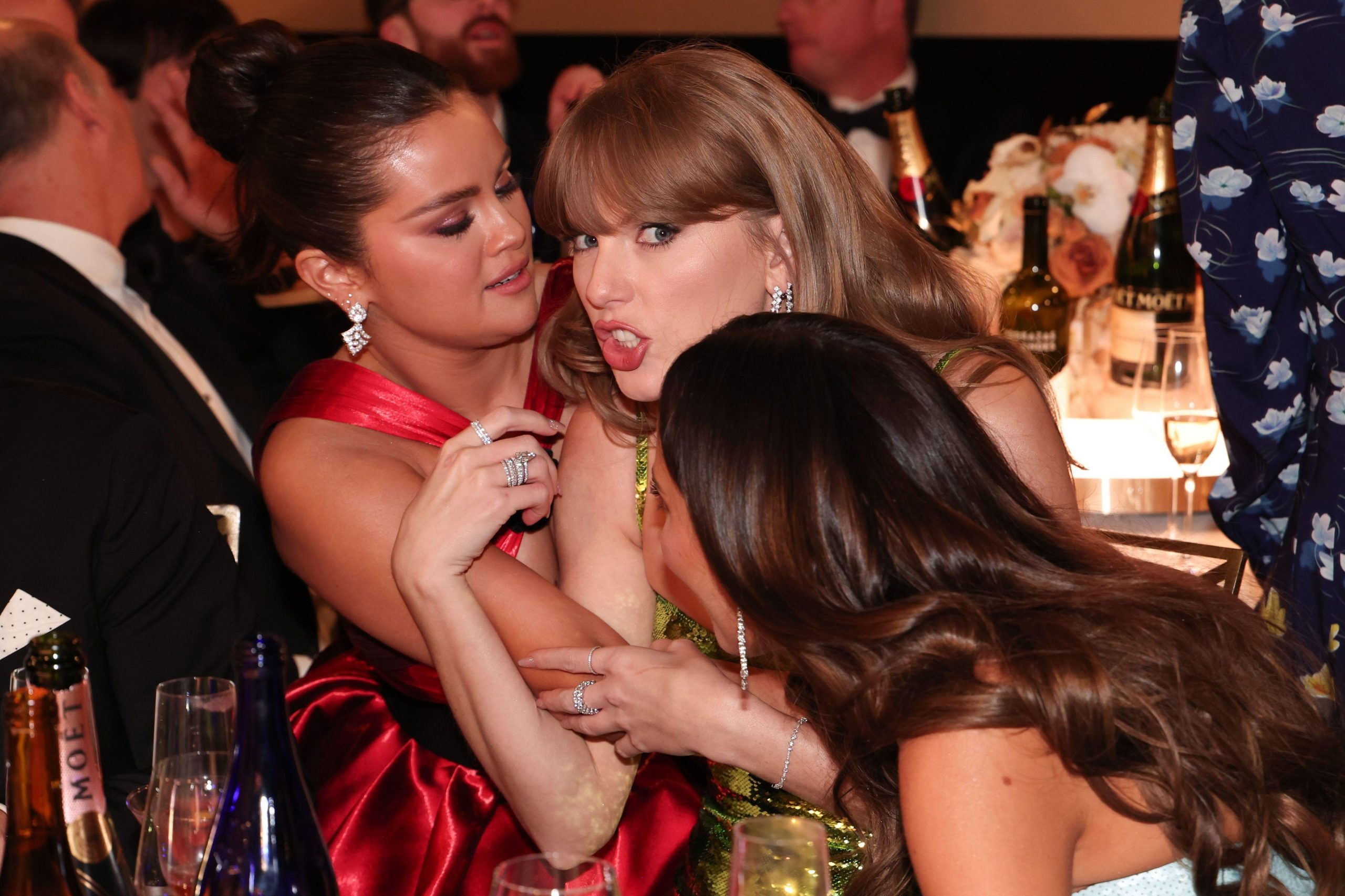 A shocked Taylor Swift hugs her best friend Selena Gomez as the actress tells her a juicy secret